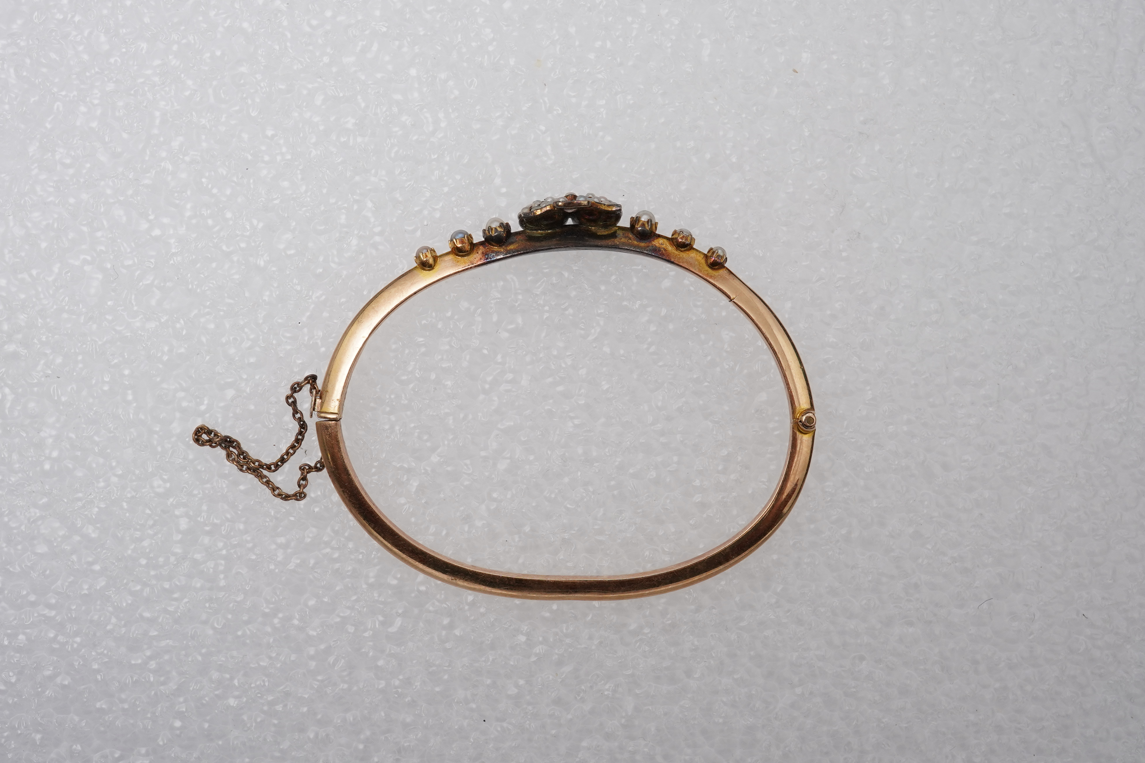 An Edwardian seed pearl and diamond bangle, early 20th century